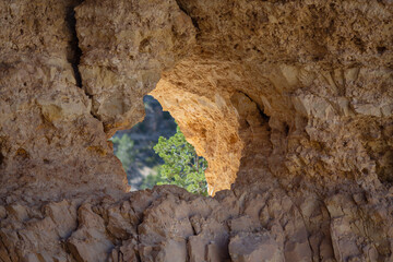 Large pothole worn over time through a wall of rock Grand Canyon