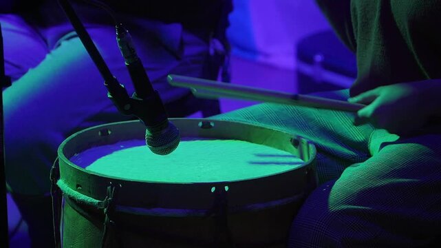 Close-up of a woman's hands playing a chacarera on the "bombo leg&uuml;ero".