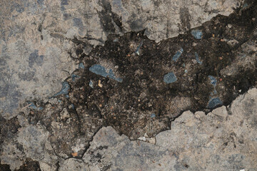 Abstract top-down texture of a cracked and weathered concrete floor, resembling a canyon. A powerful grunge background for design.