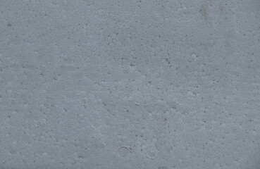 Close-up texture of a white styrofoam sheet surface. Abstract pattern background