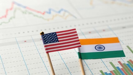 Close-up of financial chart with US and India flag overlay — concept of bilateral business analytics