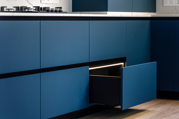 Modern blue kitchen cabinets. Minimalist kitchen interior. Stylish furniture design