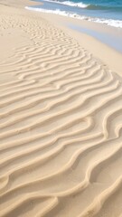 Fototapeta premium Rippled sand meets ocean waves