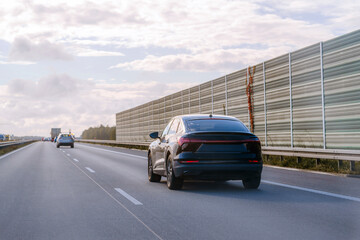 Modern car on road during sunset