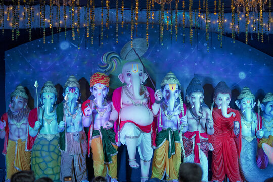 Group of Ganesh idols in colorful attire, Artistic Ganesha statues in different forms, Multiple Ganesh murti display, Festival decoration with Lord Ganesha idols stock photo.