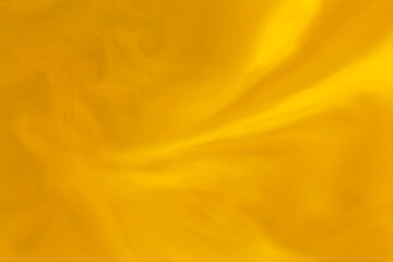 artistic backdrop: close up of golden color liquid paint stains