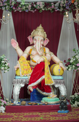 Ganesh idol in traditional attire, Lord Ganesha decorated with flowers, Artistic Ganesha murti on...