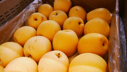 Close-up of beautiful Chinese pears in a market stall