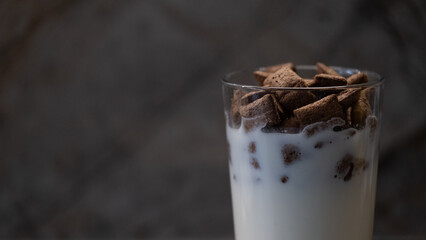 Glass of milk with chocolate cereal breakfast