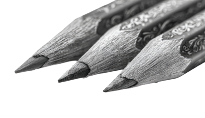 Close-up of three pencils' points, grayscale, decorative patterns on the wood