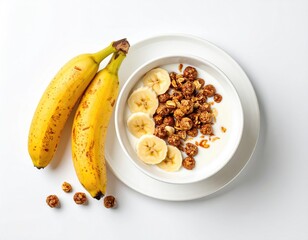 Overhead shot bowl of cereal with sliced banana, alongside two whole bananas on white. Simple breakfast concept