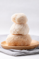 Lion's Mane mushroom or Yamabushitake mushroom on wooden plate