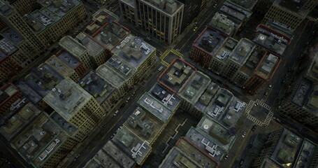 Fototapeta premium Aerial view of a city grid features densely packed buildings and intersecting streets. The rooftops show a mix of colors and textures, hinting at an urban environment.