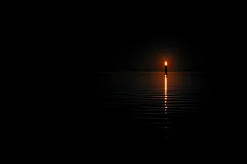 Tableau sur plexiglas Réflexion Single candle flame, reflected in still water, dark night  © mutiara