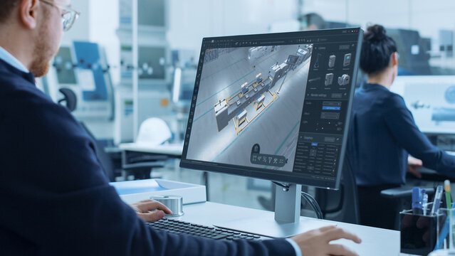 High-tech Factory Office: Industrial Design Engineer Uses 3D CAD Software to Render Autonomous Robot Arm Facility. Product Design Future Manufacturing Processes on Advanced Conveyor Assembly Line - Powered by Adobe