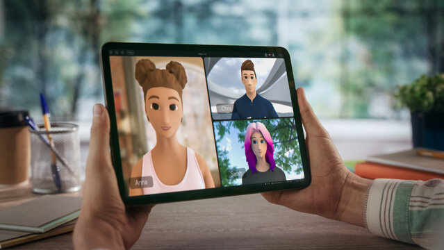 Close-up of Hands Holding Tablet During Video Call With Three Animated Avatars. Engaging in a Virtual Meeting From Home Office. Digital Interaction and Remote Connectivity in a Modern Workspace. - Powered by Adobe