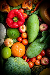 Fresh organic fruits and vegetables on wooden background
