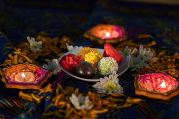 Diwali Festivities: Colorful Sweets and Diyas on Table