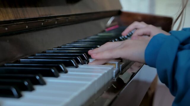 Young girl is focused and determined as she delves deep into piano lesson. Concentration remains unbroken as she navigates keys with purpose. Each note is testament to dedication to mastering melody