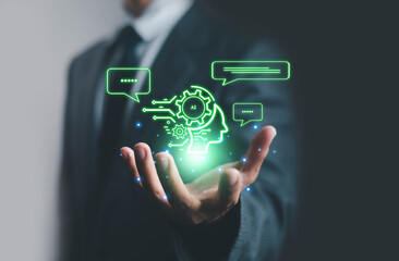 Artificial intelligence concept with digital head and gears hologram above businessman hand, symbolizing AI technology, innovation, machine learning, automation, and data communication.