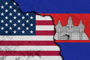 Obraz premium Torn Flags of United State Of America (USA) and Cambodia Depicting Political and Cultural Tension. Split Design of Cambodia and United State Of America (USA) Flags on Textured Surface.