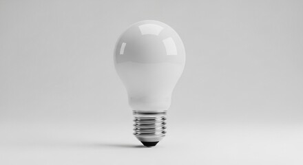 A single, bright, white LED light bulb sits centered against a clean, soft gray background, symbolizing ideas and innovation