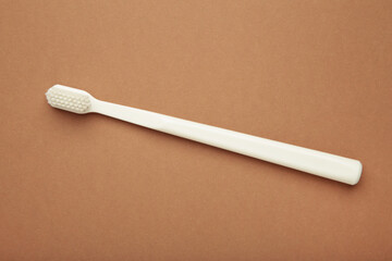 White toothbrush on brown background