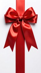 Elegant red satin bow sits centered on a white surface with a vertical red ribbon