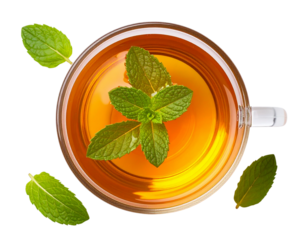 A transparent glass cup filled with herbal tea, fresh mint leaves floating on the sur 620270