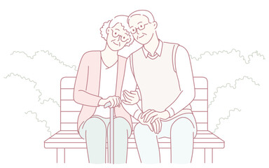 An elderly couple sits closely on a park bench, joyfully celebrating their enduring love and companionship