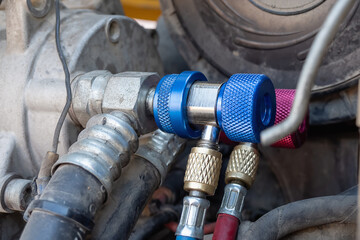 High and low pressure connecting valves for filling car air conditioner with refrigerant. Selective focus.