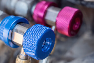High and low pressure connecting valves for filling car air conditioner with refrigerant. Selective focus.