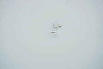 The surface or background of an old white wall with peeling paint. photo of a damp and moldy house wall