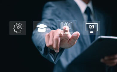 Online education and e-learning concepts. A man interacts with e-learning icons virtually,...