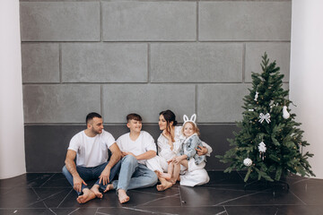 Family father, mother, son and daughter celebrate Christmas together, happy, stylish