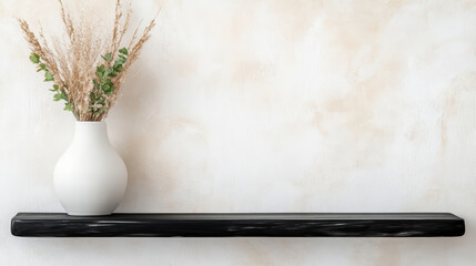 Minimalist white ceramic vase with dried flowers sits sleek black shelf against textured beige