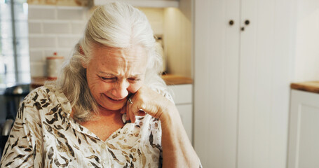 Sad, senior woman and crying at house with depression, mourning loss and trauma memory. Emotional, elderly person and grief for broken heart, loneliness and sorrow of bad news with nostalgia distress