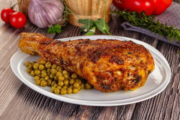 Baked turkey drumstick served green peas