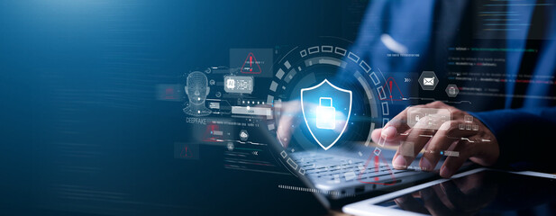 Close-up of businessman using digital tablet with hologram security lock icon. Concept of cybersecurity, data protection, encryption, AI technology, and online privacy.