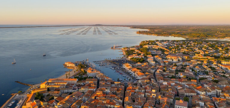 Aerial panorama of Meze at sunrise, in Occitanie, France