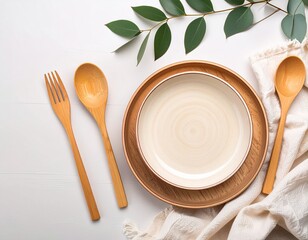 A natural, pastel background with plates, wooden cutlery, a linen cloth, and a green sprig. Table setting, tableware