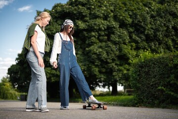 Friends enjoying a sunny afternoon while skateboarding in the park
