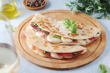 Traditional Italian dish Piadina romagnola - flat bread with mozarella and proscuitto	