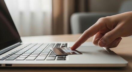 Female hand using credit card on laptop for online shopping transaction
