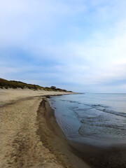 Baltic Sea. Beach in Russia, Kaliningrad. Golden beach of the sea. The water is choppy and the sky is cloudy