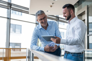 Business professionals collaborating and smiling in modern office