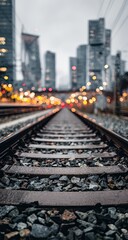 Naklejka premium Urban railway tracks stretching into a city. Blurred cityscape in background
