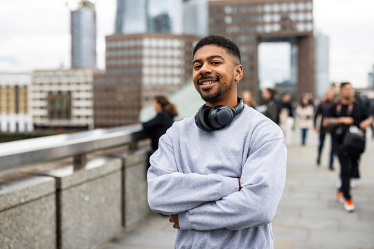Confident man with headphones posing on London street outdoors