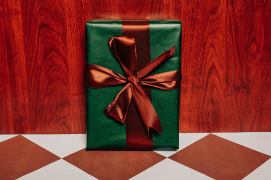 Handmade vintage Christmas gift box with ribbon on retro floor