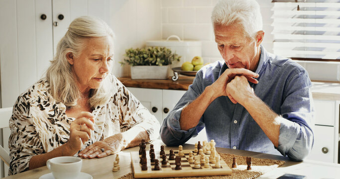 Thinking, senior couple and playing chess in home with decision, problem solving and strategy. Retirement hobby, elderly people and bonding with board game in house for challenge and cognitive skills